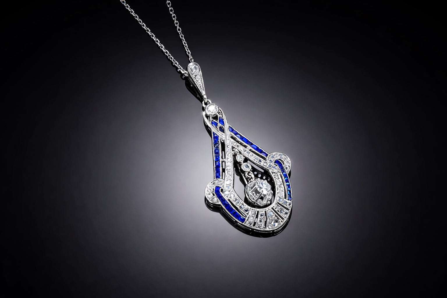 Pendentif et sa chaîne diamants et saphirs calibrés Art déco. Travail français vers 1930.